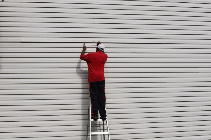 Repair Technician Installing Siding